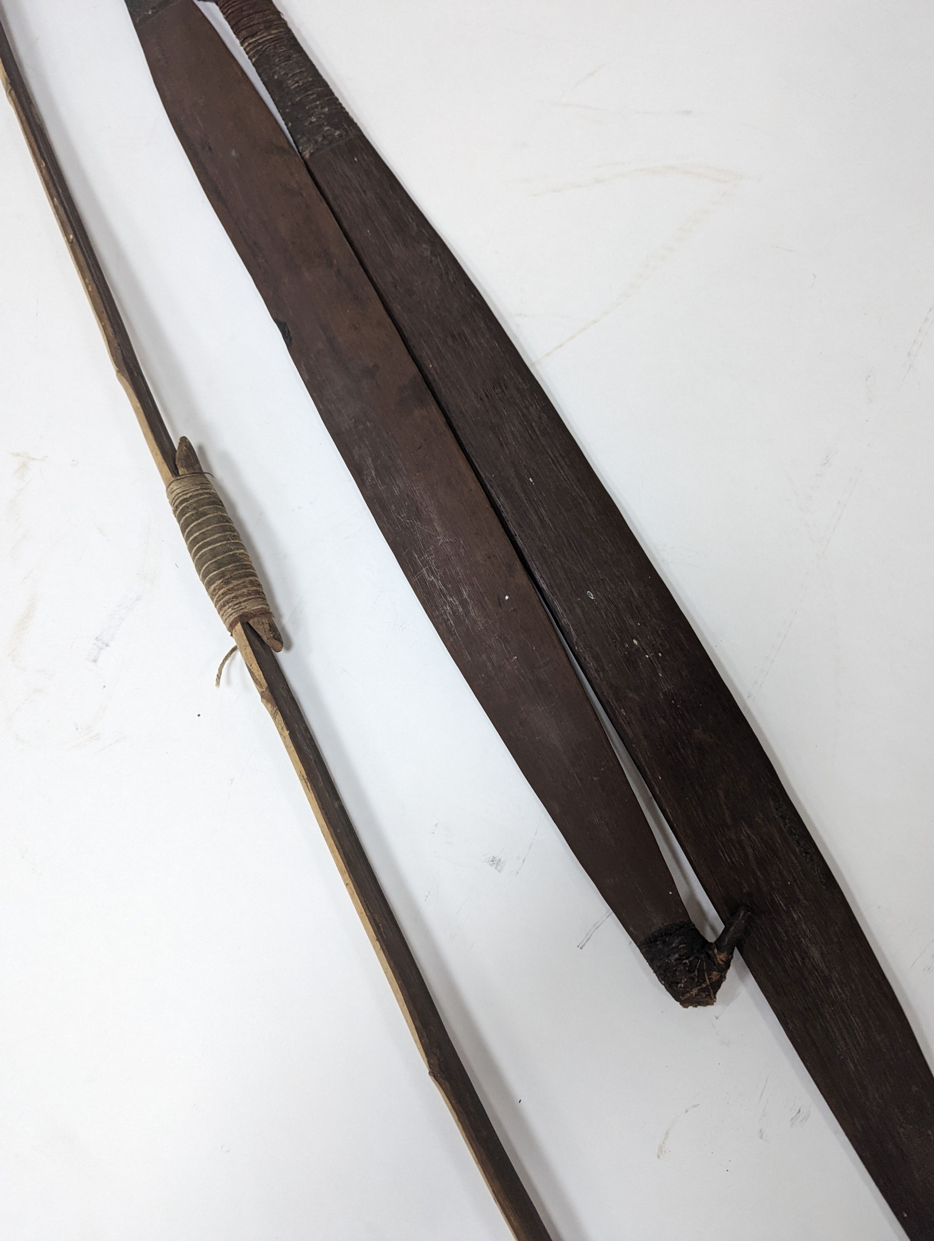 Two chip-carved paddle blades and bow, possibly Fijian.